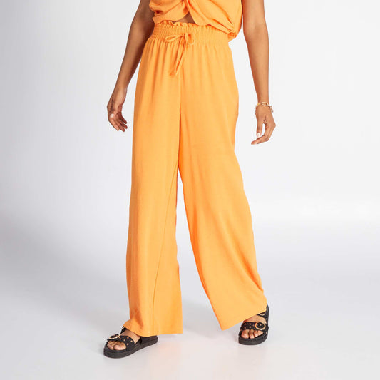 Satiny knit fabric wide-leg trousers orange